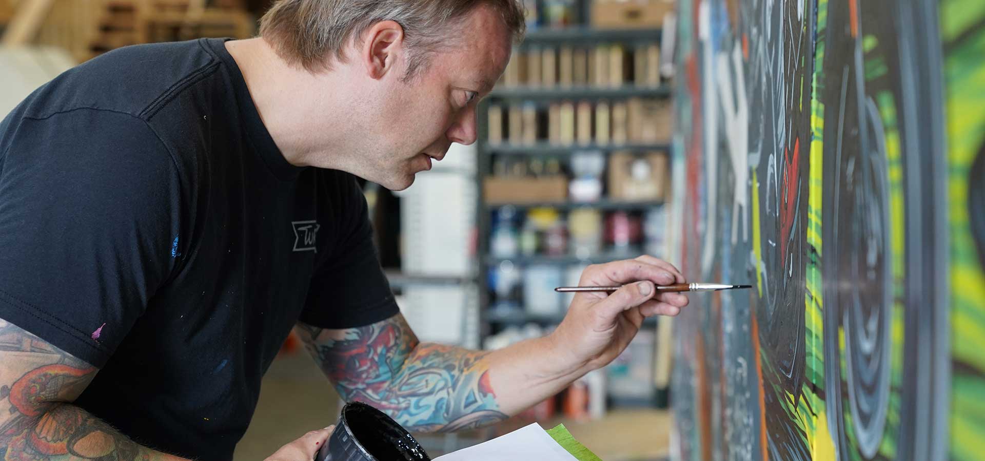 Adam Turman painting a picture