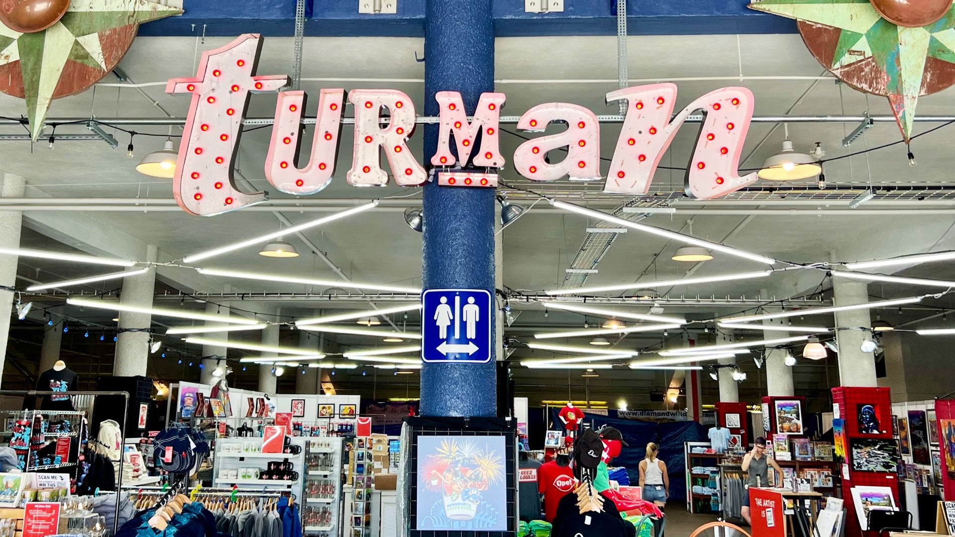 Minnesota Artists - a store with a sign and a group of clothes